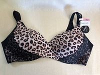 Front side of new La Vie En Rose bra size 38C with leopard print cups and black lace trim, adjustable black straps visible.