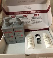 Open box showing four items of the LifeCell Hair Restoration Kit with clear labeling and instructions inside the lid.