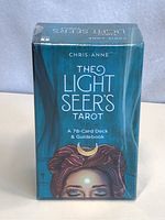 Front of the sealed box showing the title, author Chris-Anne, and illustration of a figure with a crescent moon on forehead.