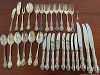 All 29 pieces laid out by type on wooden table.