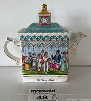 Full side view of rectangular Sadler ceramic teapot with The Tennis Match scene, white body, blue-green roof, gold accents.