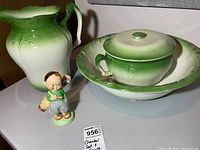 Green and white gradient ceramic jug, lidded bowl with matching underplate, and Shelley figurine boy with golf bag in front