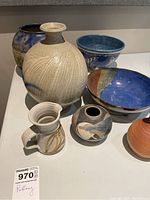 Overview of all seven ceramic items on display