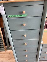 Front view of the dresser showing seven drawers with wooden knobs and a note with measurements 24 x 20 x 57 inches.