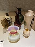 Group view of all seven vases on table
