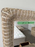 Close-up of wicker weave texture on mirror frame with tape showing 37" x 24" measurements