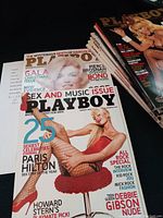 Front cover of one 2005 edition of Playboy magazine featuring Paris Hilton in fishnet stockings, highlighting it as the Sex and Music issue with additional celebrities and special features.