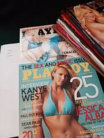 Stack of 12 Playboy magazines from 2006, visible covers showing celebrity models and magazine titles.
