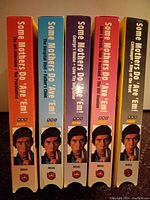 Front spines of 5 VHS tapes showing titles and a photo of the main character from the BBC comedy series Some Mothers Do 'Ave 'Em.