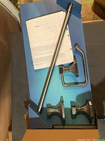 Unboxed Richelieu 4-piece bathroom hardware set showing the towel bar, towel ring, and 2 robe hooks in brushed nickel finish.