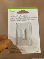Front packaging of Cricut Premium Fine Point Blade showing blade in plastic casing with label and product info.