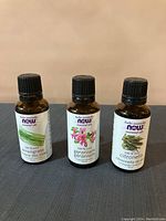 Three bottles of Now essential oils: Lemongrass, Geranium, and Citronella, unopened and full.