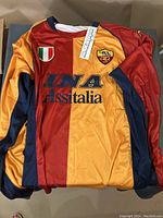 Front view of AS Roma jersey with INA Assitalia sponsor logo, Kappa branding, Italian Scudetto patch, and club crest.