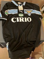 Front view of black SS Lazio Puma football jersey showing Cirio sponsor branding, club crest, Puma logo, and Lega Serie A patch on sleeve.