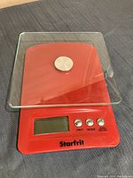 Red Starfrit digital kitchen scale with glass platform and control buttons UNIT, MODE, ZERO ON/OFF