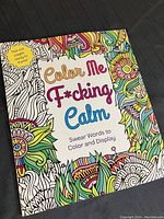 Front cover of the colouring book showing colorful floral and abstract design with title 'Color Me F*cking Calm Swear Words to Color and Display'.