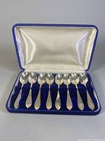Eight coffee spoons in blue velvet-lined fitted box