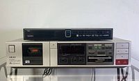 SEIKI BD660 Blu-Ray Disc Player stacked on top of AKAI GX-A5X Stereo Cassette Deck showing front panels.