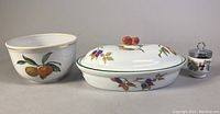 Three pieces of Evesham servingware: serving bowl, oval casserole with lid, and egg coddler. Showing full set for identification and condition.