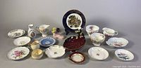 Overview of all assorted vintage chinaware items including vase, ashtray, dishes, plates, creamers, and sugar bowls displayed together.