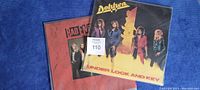 Top view of the vinyl record covers for Dokken and Bad English, showing artwork and condition