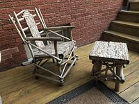 Side angle view of the bark panel chair and matching table on a wooden deck showing rustic construction and materials.