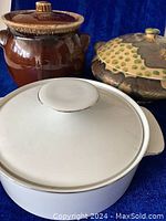 Photo showing the three pots: brown ceramic bean pot by HULL USA, a decorative terracotta casserole bean pot from Italy, and a white porcelain casserole dish with lid