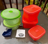 Photo showing the full set of Tupperware Stuffables containers in green, red, and one blue container along with instruction manual.