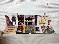 Wide shot showing all vinyl LPs arranged on a shelf with pegboard background.