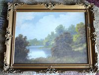Framed antique pastel landscape painting depicting a river and trees, showing overall item and frame.