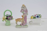 Front view of the porcelain figure and two flower bouquet arrangements showing details and colors