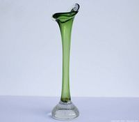 Tall green glass bud vase with a controlled bubble clear glass foot, showing front profile against a white background