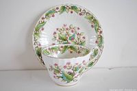 Teacup and saucer placed together showing floral design and shape