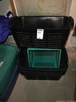 Image showing three stacked black meshed plastic bins with a green milk crate bin placed inside the middle black bin.