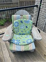 Front view of the Muskoka chair with both cushions on the seat and backrest, showing the floral and striped cushion patterns.