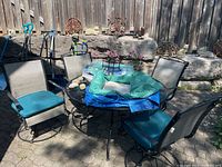 Four swivel chairs arranged around patio table outdoors