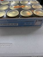 Photo shows unopened boxed set of 12 Anchor Hocking 1/2 pint smooth side regular mouth canning jars with lids and bands for food preservation.