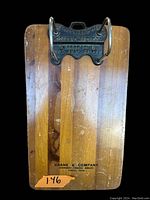Full view of the antique wooden clipboard showing metal clamp and Crane & Company print at bottom