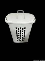 White plastic clothes hamper with lid and handle, ventilation holes on sides, on wheels.