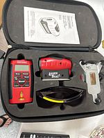 Craftsman Laser Level and all included accessories arranged neatly in molded carrying case.