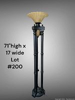 Tall floor lamp shown against plain background with measurements 71 inches high by 17 inches wide labeled in photo. Lamp has black base and vertical stand with two lights, the top one with beige glass shade.