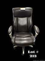 Front view of black leather office chair showing padded seat, high backrest, and armrests with silver frame.