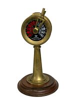 Mini brass nautical engine order telegraph showing red and black indicator dial with lever, mounted on a wooden round base