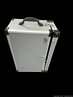 Closed view of the silver aluminum rolling jewelry case with black handle and corner protectors