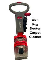 Front view of Rug Doctor carpet cleaner showing handle, control switch, power cord, and transparent cleaning tanks.