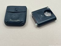 Pouch with snap closure and pocket magnifier tool side by side