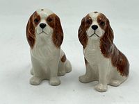 Front view of two Cocker Spaniel porcelain salt and pepper shakers showing detailed facial features and posture