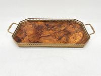 Side view of the entire tray showing brass handles and edge framing with visible aged patina on metal and wood.