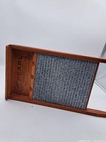 Full view of washboard showing wooden frame and metal scrubbing surface.