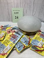 Photo of frosted glass vintage ceiling light and twelve ProZap Insect Guard Jr packets arranged on wooden floor.